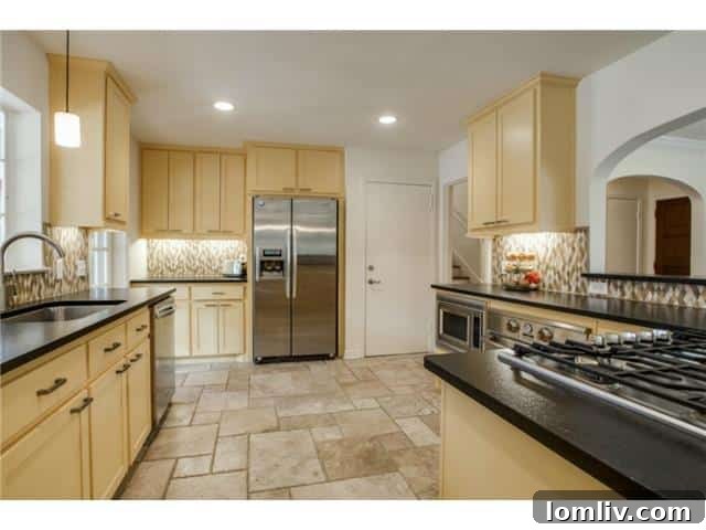 The newly renovated custom kitchen at 1108 Valencia with geometric backsplash and granite counters