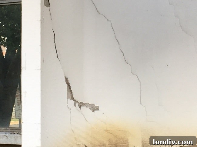 Severe facade cracks and deterioration on the Cabana Hotel building, highlighting need for redevelopment