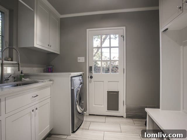 Spacious and highly organized mudroom with custom cabinetry and storage solutions.