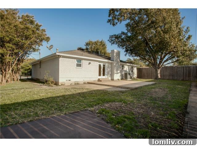 Spacious backyard with a new eight-foot cedar privacy fence and mature trees