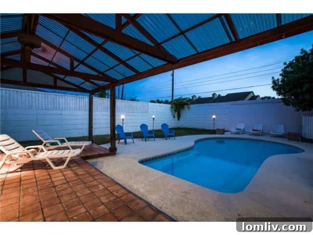 Stunning backyard with swimming pool and patio awning, ideal for entertaining at 13016 Fall Manor