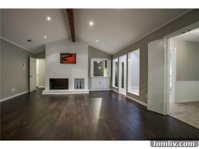 View of the open concept living area showcasing cedar beams in 13016 Fall Manor
