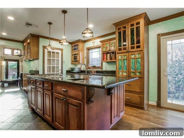 Modern kitchen featuring stainless steel appliances, a large central island, and stylish cabinetry
