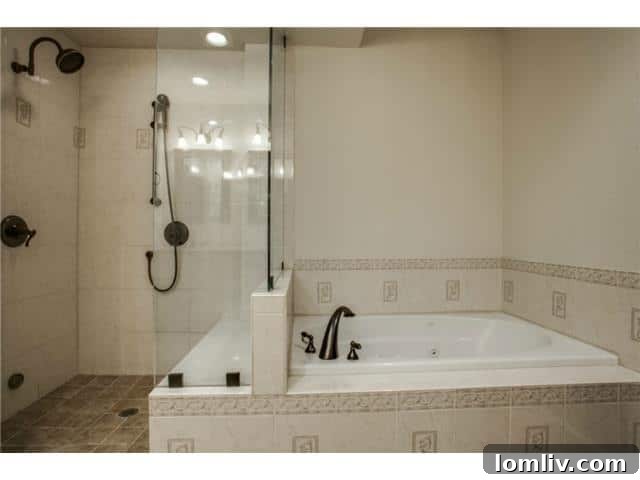 Dual vanity sinks and modern fixtures in the beautifully renovated master bath