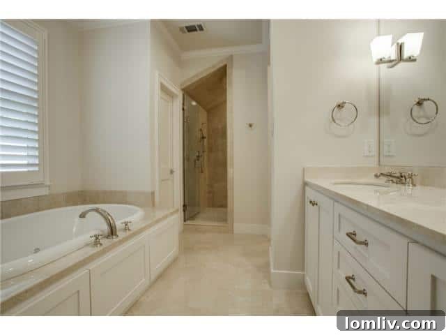 Spacious and elegant secondary bathroom, highlighting functional design and ample counter space