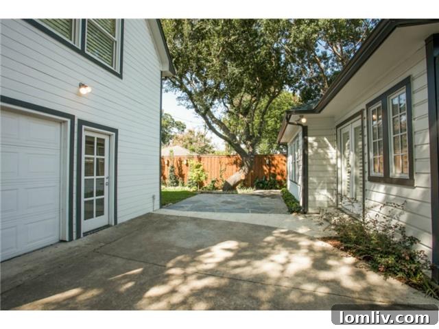 Rear view of the beautiful home and the detached guest quarters above the garage