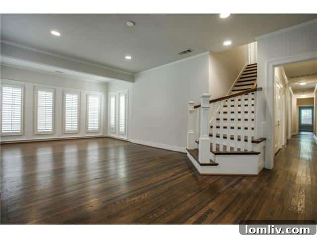 Bright and spacious living room at 5234 Monticello, featuring rich hardwood floors and plantation shutters