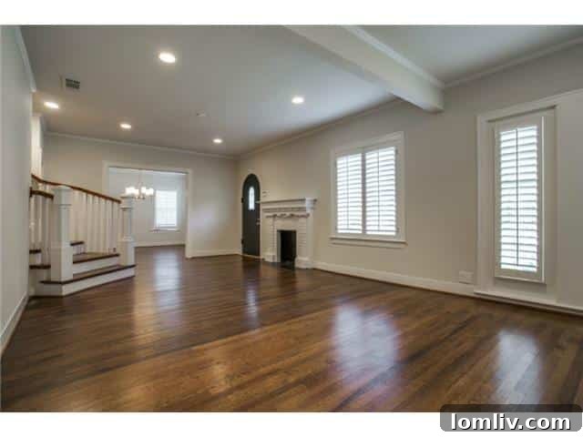 Inviting living room with a charming fireplace and ample natural light, ideal for entertaining