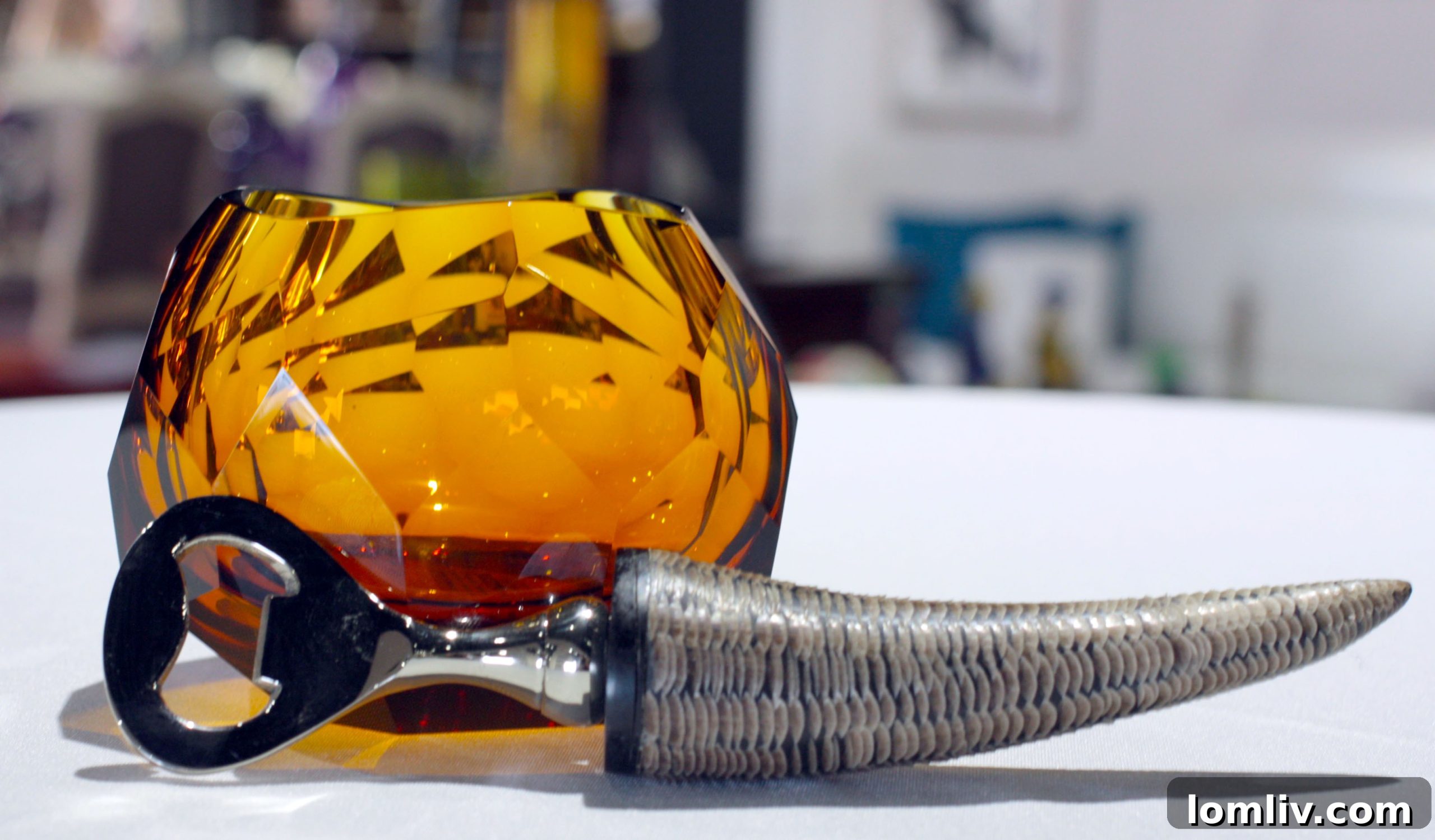 Vibrant Bohemian crystal glasses paired with a stylish horn bottle opener, perfect for elegant holiday entertaining