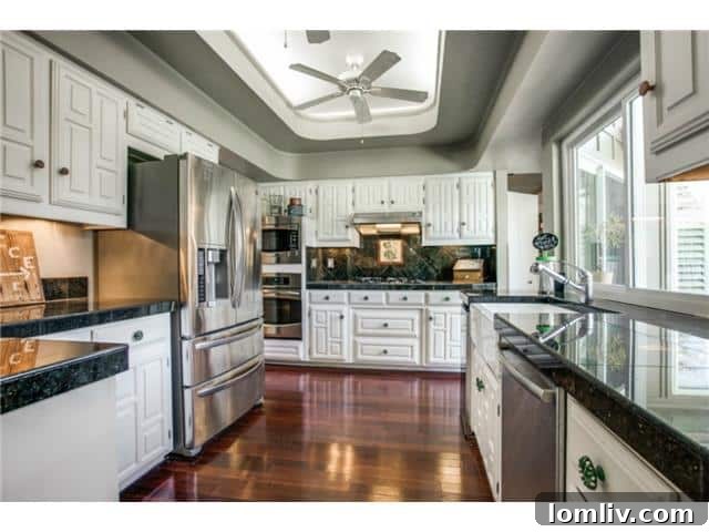 Updated kitchen with stainless steel appliances and granite countertops
