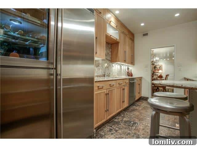 Stunning Views, Incredible Value 6 Athena-unit-1416-Kitchen-1: Modern kitchen with custom cabinets and granite countertops.