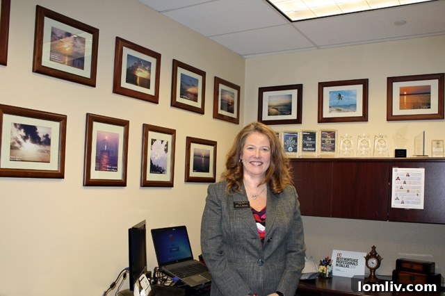 Julie Nichols' office adorned with coastal sunset photos, reflecting her passion for the beach.