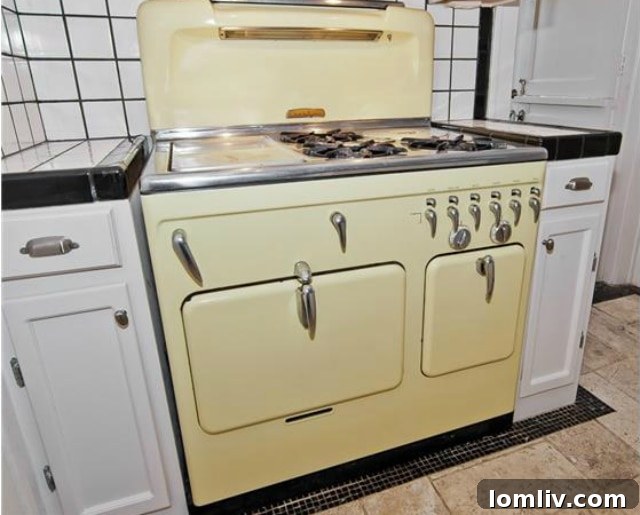 Historic North Oak Cliff Tudor: Stained Glass and Chambers Stove Legacy 11 Close-up view of the pristine vintage butter-yellow Chambers gas stove, a highlight of the kitchen