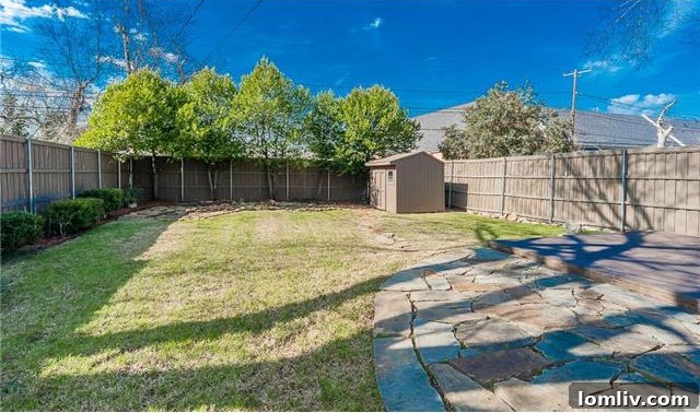 Historic North Oak Cliff Tudor: Stained Glass and Chambers Stove Legacy 19 View of the convenient carport and a portion of the spacious backyard, offering covered parking and green space