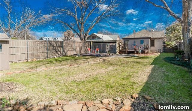 Historic North Oak Cliff Tudor: Stained Glass and Chambers Stove Legacy 20 Panoramic view of the well-maintained landscaped backyard, including the shed and mature perimeter trees