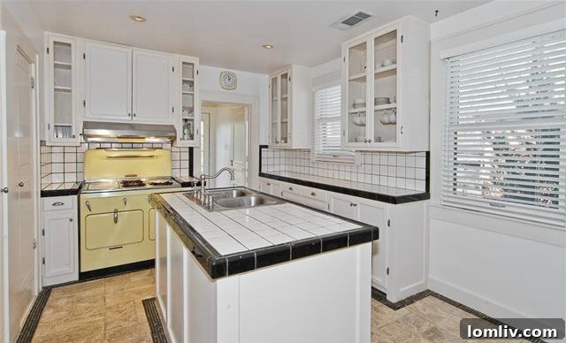 Historic North Oak Cliff Tudor: Stained Glass and Chambers Stove Legacy 8 Kitchen interior of 1325 Hollywood Ave featuring vintage black and white ceramic tiles and glass-front cabinets