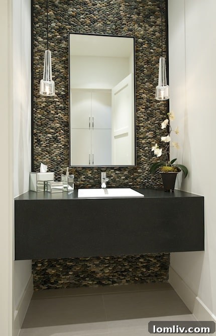Dallas Home Builder Tatum Brown Earns Best of Houzz 3 Luxurious modern powder bath with natural stone wall and sleek fixtures by Tatum Brown Custom Homes