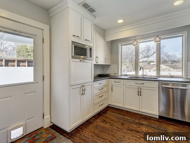 Another view of the gourmet kitchen, showcasing custom cabinetry, sleek design, and ample workspace