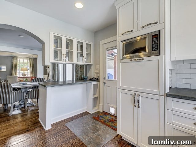 Detailed shot of the kitchen island with modern seating, stylish pendant light fixtures, and bright atmosphere