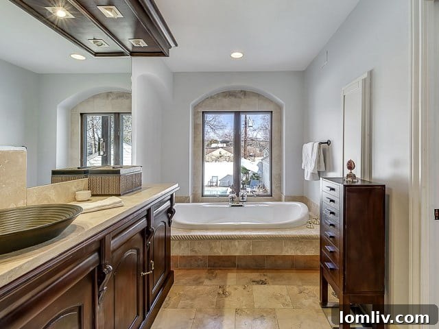 Elegant master bathroom with a freestanding tub, stylish vanity, and natural light