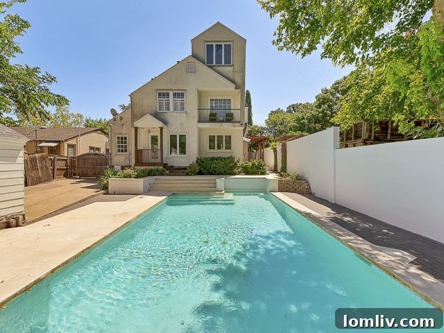 Another angle of the serene backyard, showcasing the pool, manicured landscaping, and private outdoor living space