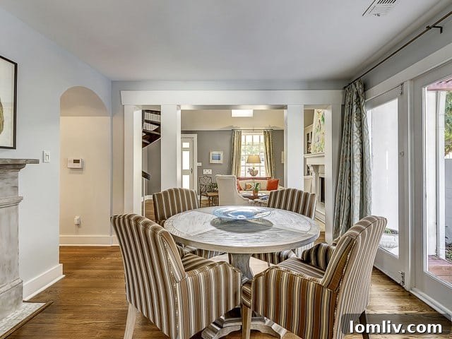Formal dining room with full-light French doors opening to an outdoor patio and arbor