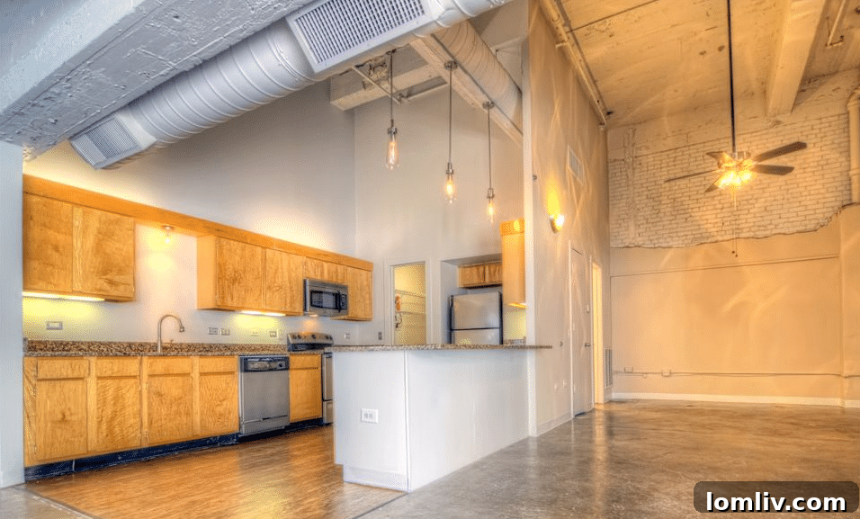 Interior loft view at 1900 Elm with high ceilings and large windows.