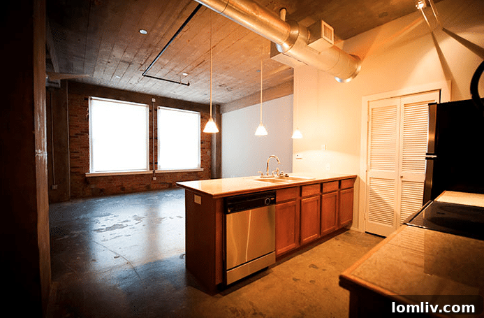 Modern interior of an Interurban Building loft with exposed brick walls.