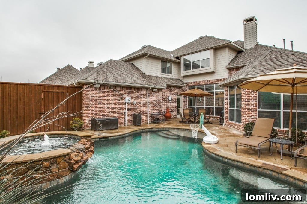 The beautifully landscaped backyard, providing a private and serene setting around the pool and patio.