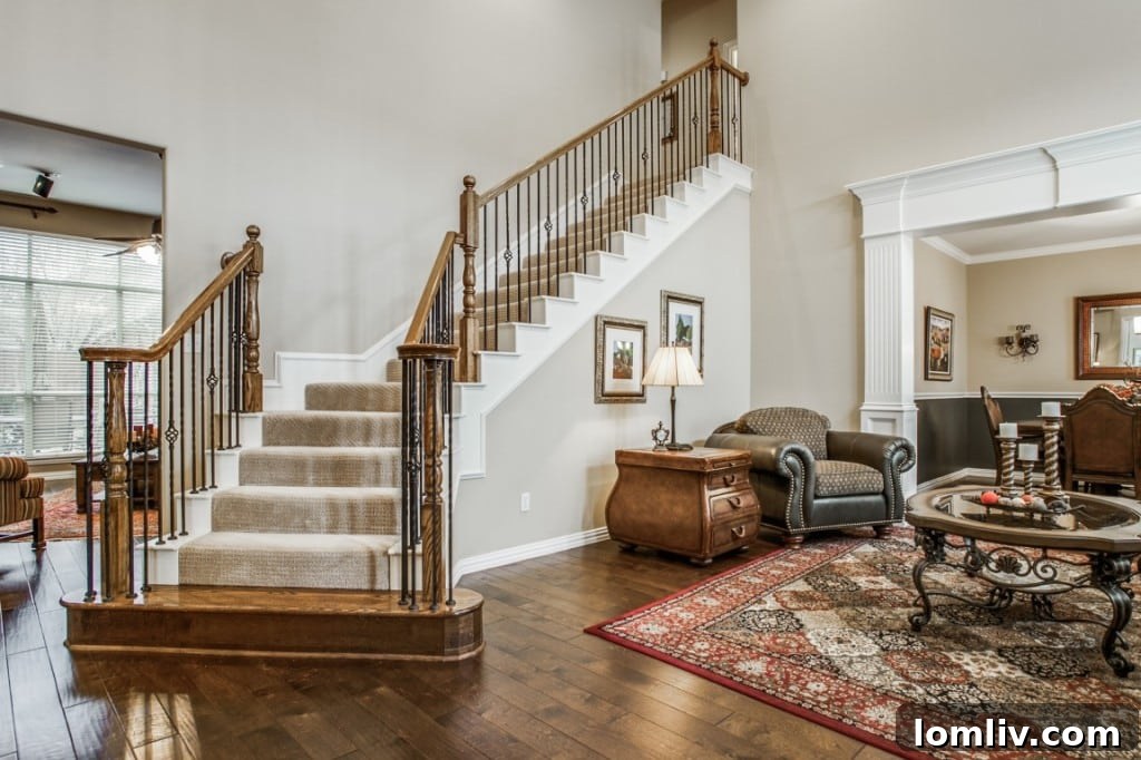 A spacious living room featuring a cozy fireplace, large windows with plantation shutters, and a neutral paint palette.