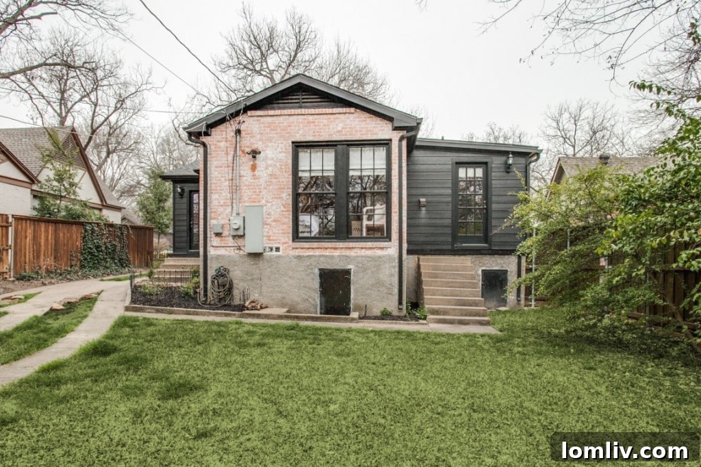 The beautifully landscaped backyard of 6918 Patricia Ave, featuring green grass and mature privacy hedges, ideal for outdoor living.
