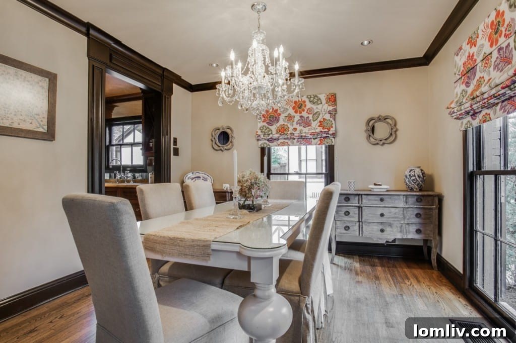 A detailed view of the living room, showcasing custom crown molding, a fireplace, and elegant furnishings.
