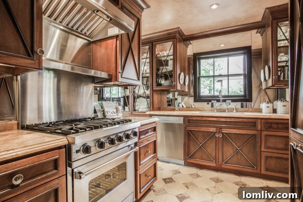 A sophisticated kitchen featuring an onyx slab island, high-end appliances, and custom cabinetry with lighted displays.
