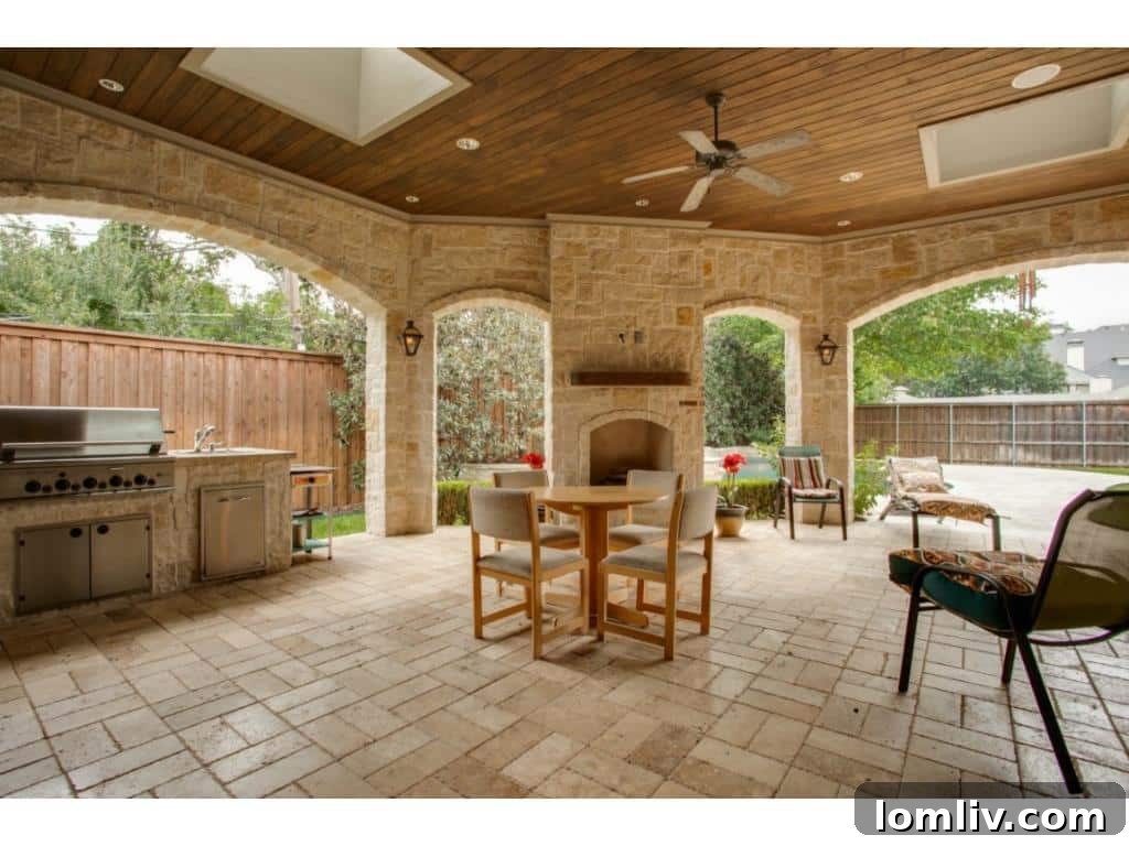 The luxurious outdoor living area of 4436 Brookview, featuring a sparkling pool, patio, and lush landscaping.