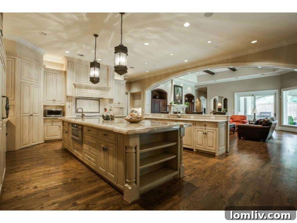 A state-of-the-art gourmet kitchen at 4436 Brookview, featuring two expansive 12-foot stone islands and high-end appliances.