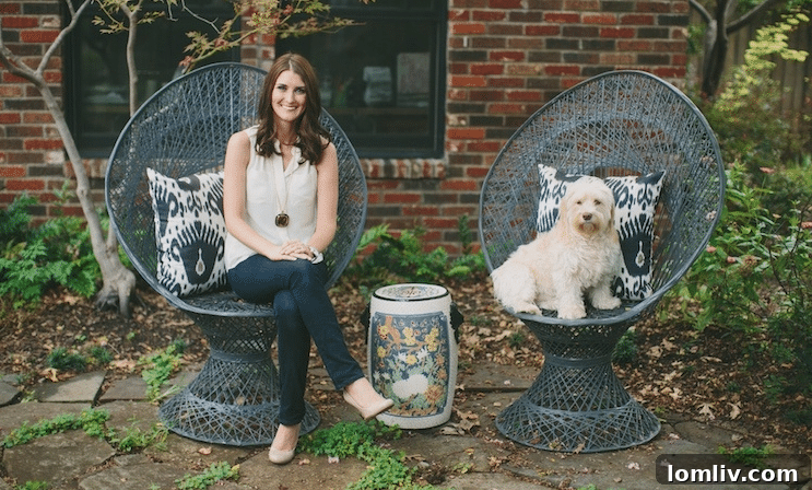 Interior designer Emily Larkin with her dog Zoe in the backyard of her Hollywood Heights home, 707 Cordova, showcasing her creative space.