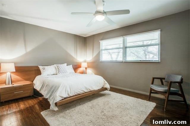 Bright master bedroom with a large window and minimalist decor