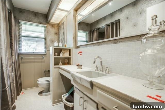 Close-up of the master bath's vintage wallpaper and elegant vanity