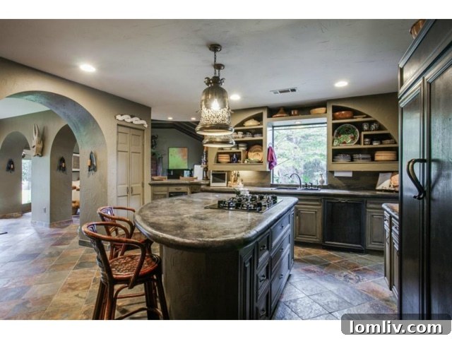 Gourmet Kitchen with Concrete Counters and Custom Cabinetry at 6701 Inwood