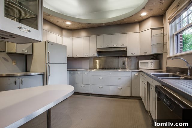 Vintage 1950s remodeled kitchen at 5803 Swiss Avenue with well-preserved cabinetry, ready for a modern transformation