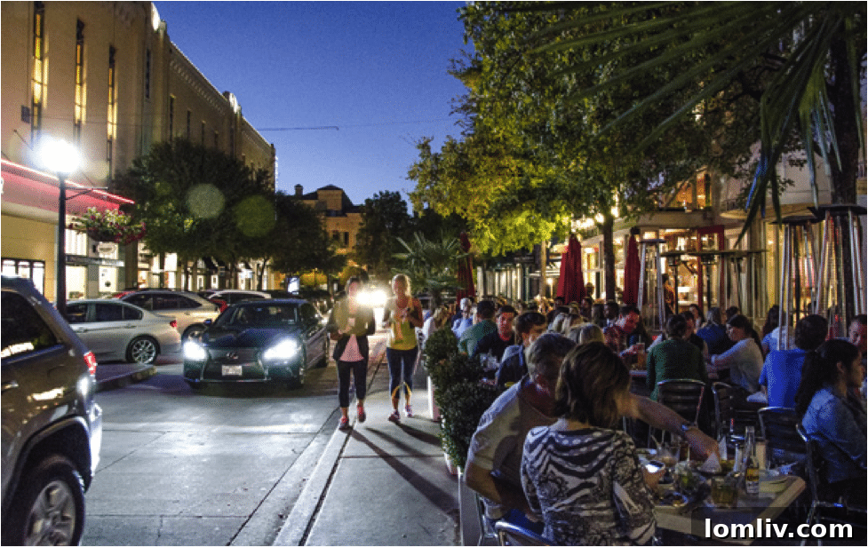 People enjoying a vibrant evening at West Village Dallas patio