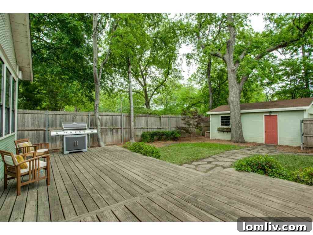 Spacious backyard deck, perfect for outdoor entertaining and relaxation amidst lush greenery.