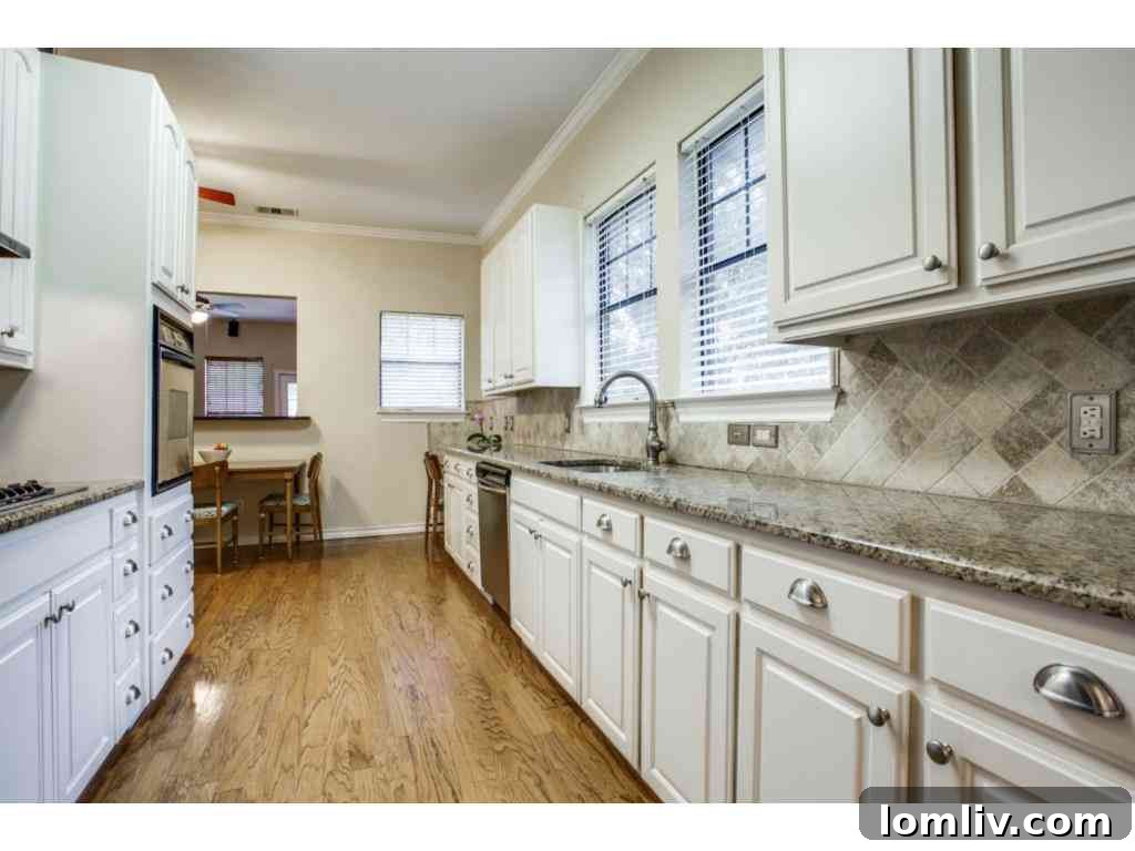 Modern kitchen with stainless steel appliances, granite countertops, and plenty of natural light.