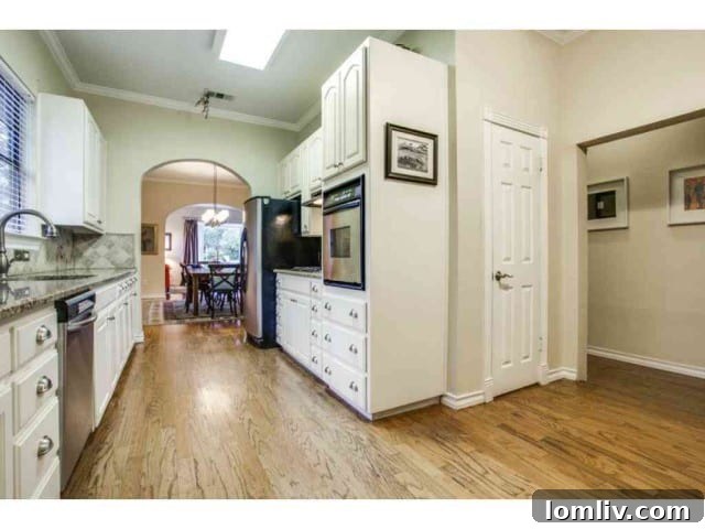 Another perspective of the kitchen, emphasizing its spacious layout and modern finishes.
