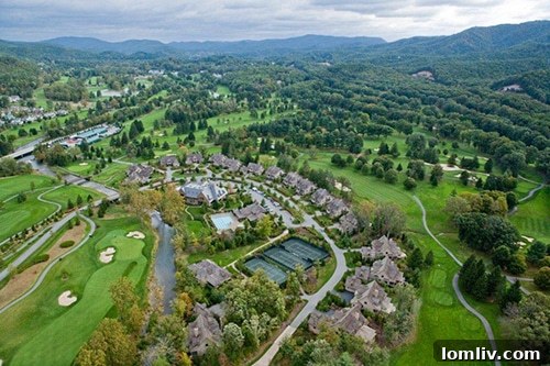 The Greenbrier Sporting Club clubhouse with scenic views of the surrounding hills, embodying luxury and outdoor living.