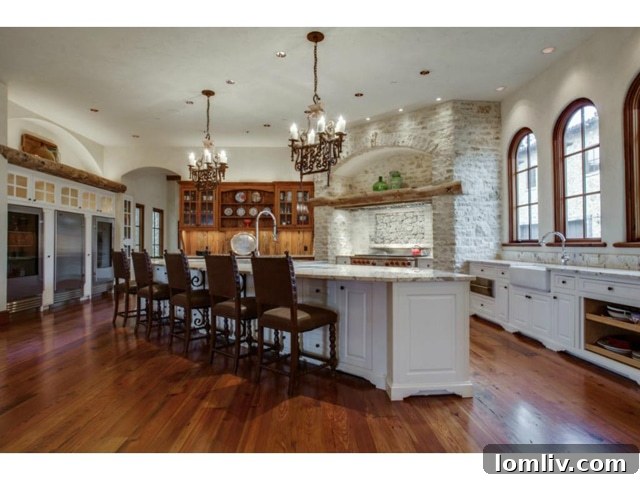 Gourmet kitchen with island, stone walls, and high-end appliances in luxury home