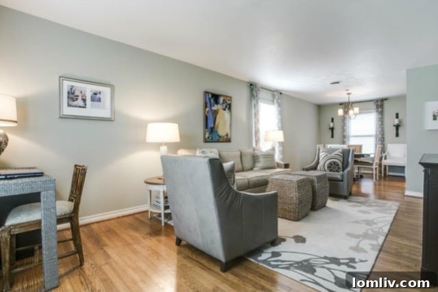 Bright and spacious living room with soft green-beige walls in the renovated midcentury home