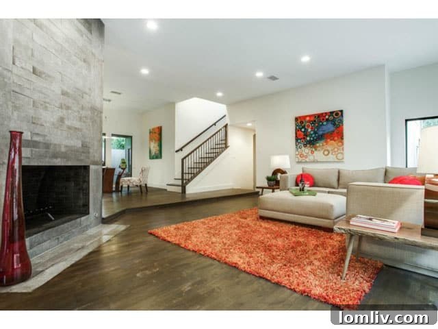 Spacious Living Area with Dark Hardwood Floors and Tall Windows