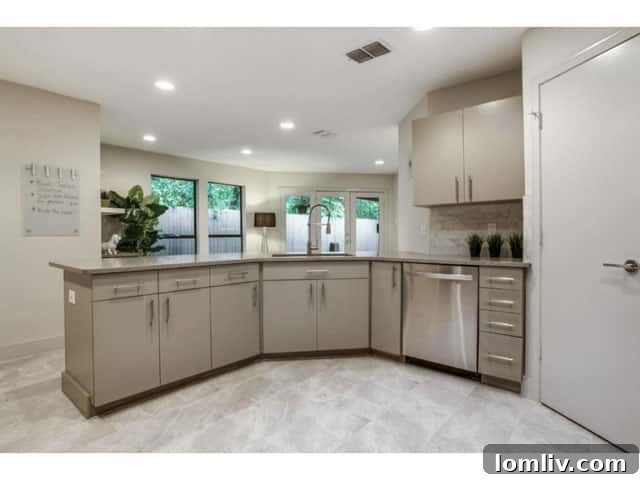 Modern Kitchen with Stainless Steel Appliances and Engineered Stone Counters