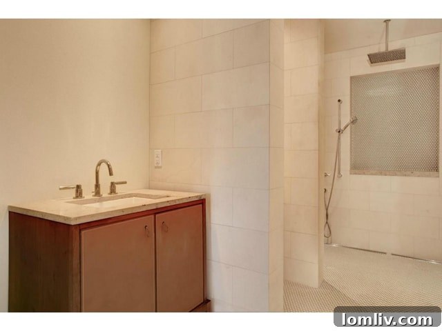 Stylish guest bathroom with modern fixtures and finishes in the luxury Fort Worth home.